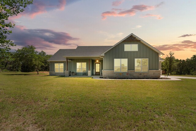 1295 County Road 2030, Glen Rose, TX 76043 - view of front of home with board and batten siding, a yard, and roof with shingles