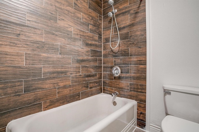 bathroom featuring shower / washtub combination and toilet