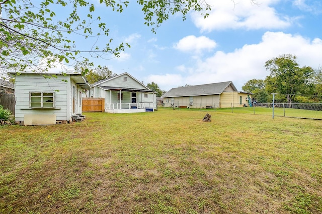 view of yard featuring a fenced backyard and a porch