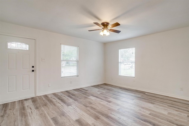 entryway featuring plenty of natural light, a ceiling fan, and light wood-style floors
