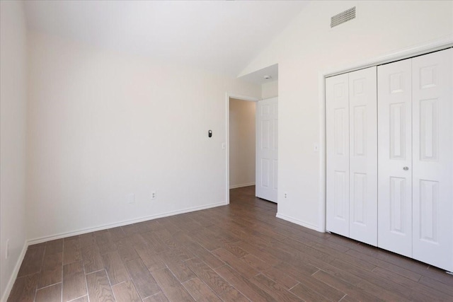 102 Park Cir, Mckinney, TX 75069 - unfurnished bedroom featuring dark wood-style flooring, vaulted ceiling, baseboards, and a closet