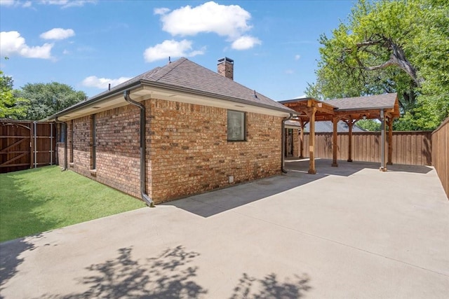 102 Park Cir, Mckinney, TX 75069 - rear view of house with a patio area, a chimney, brick siding, and a shingled roof