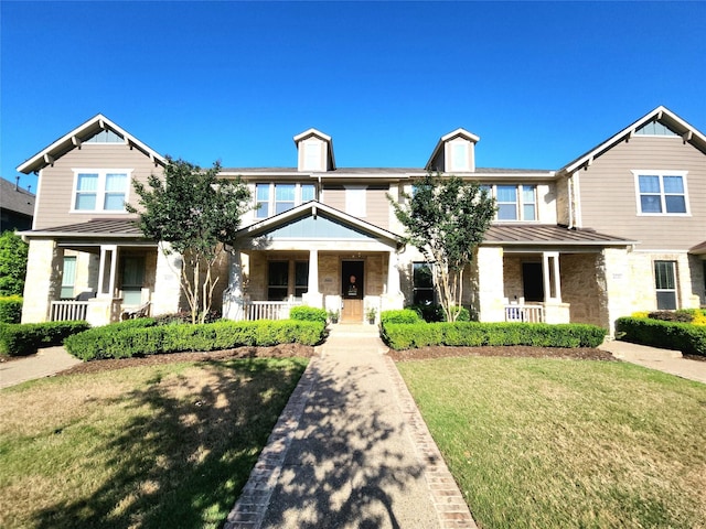 4223 Cascade Sky Dr, Arlington, TX 76005 - view of front of home featuring a front yard, stone siding, covered porch, and a standing seam roof