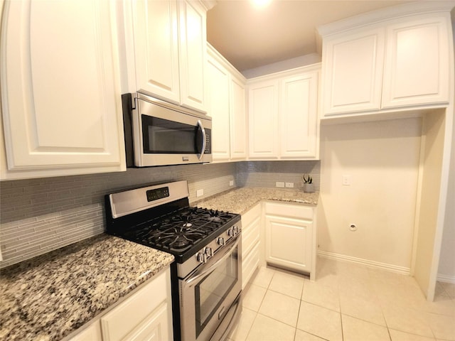 4223 Cascade Sky Dr, Arlington, TX 76005 - kitchen featuring appliances with stainless steel finishes, light tile patterned floors, light stone counters, and backsplash