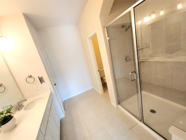 4223 Cascade Sky Dr, Arlington, TX 76005 - full bathroom featuring tile patterned floors, a shower stall, toilet, vanity, and baseboards