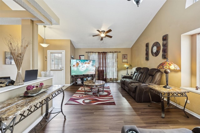 living room featuring ceiling fan, vaulted ceiling, wood finished floors, and baseboards