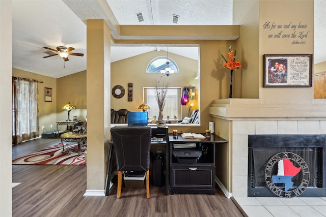 living room with visible vents, wood finished floors, a ceiling fan, and lofted ceiling