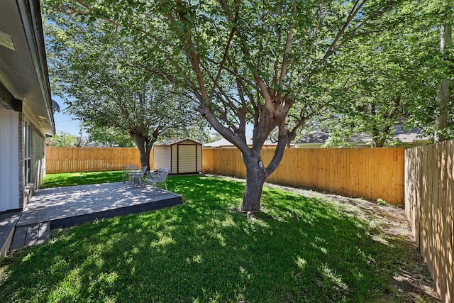 view of yard featuring an outdoor structure, a patio, a shed, and a fenced backyard