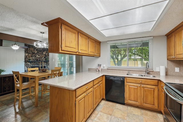 kitchen featuring brown cabinets, a fireplace, a sink, a peninsula, and black dishwasher