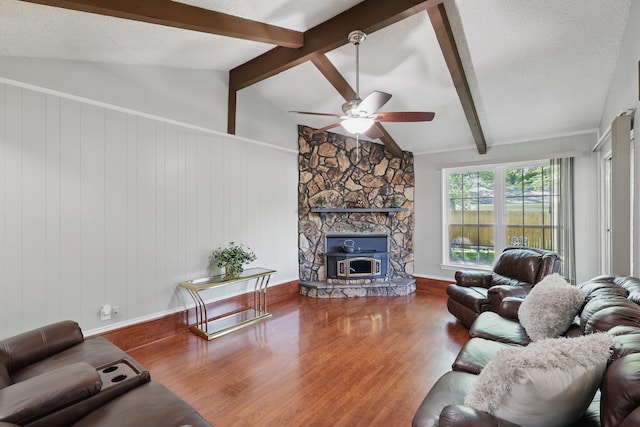 living room with ceiling fan, wood finished floors, vaulted ceiling with beams, and a textured ceiling
