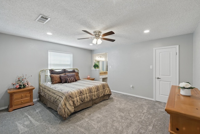 carpeted bedroom with ensuite bathroom, baseboards, visible vents, recessed lighting, and ceiling fan