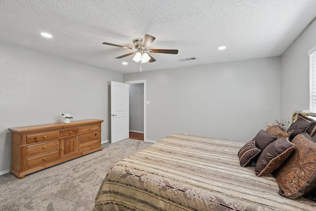 bedroom featuring a textured ceiling, ceiling fan, light colored carpet, visible vents, and recessed lighting