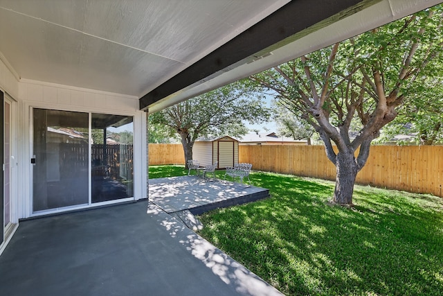 view of patio / terrace with an outbuilding, a shed, and a fenced backyard