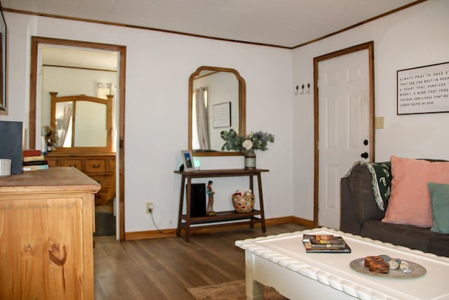 living room with baseboards, wood finished floors, and crown molding