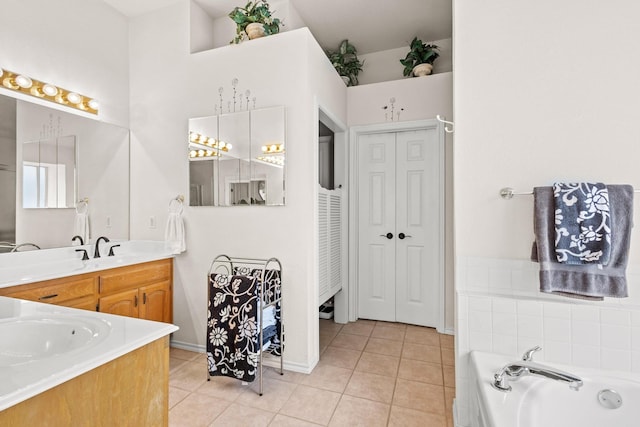 full bathroom featuring a garden tub, tile patterned flooring, and vanity