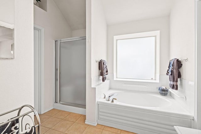 full bath featuring tile patterned floors, a garden tub, and a stall shower