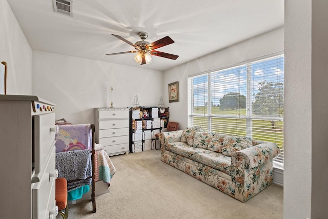 carpeted bedroom with visible vents and ceiling fan