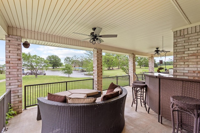 view of patio featuring an outdoor hangout area, a ceiling fan, outdoor dry bar, and a water view