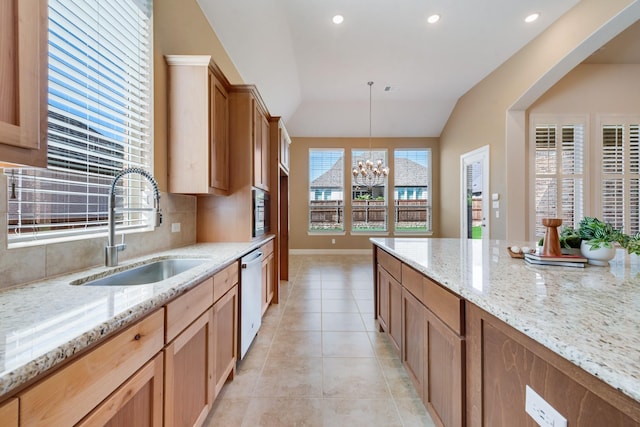 kitchen featuring vaulted ceiling, a sink, light tile patterned flooring, a chandelier, and dishwasher