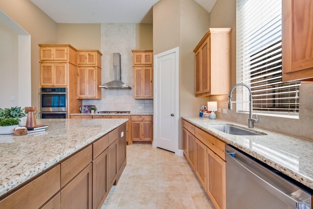 2316 Miranda Ln, Rockwall, TX 75087 - kitchen with appliances with stainless steel finishes, wall chimney exhaust hood, a sink, backsplash, and light stone countertops