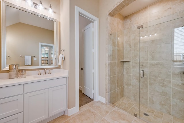 bathroom with vanity, tile patterned flooring, and a stall shower