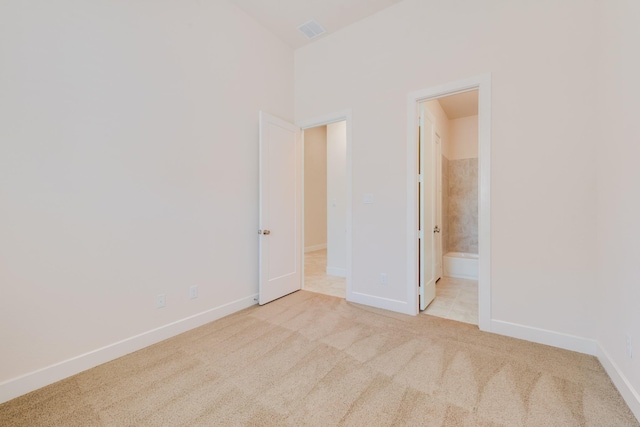 carpeted empty room with baseboards and visible vents