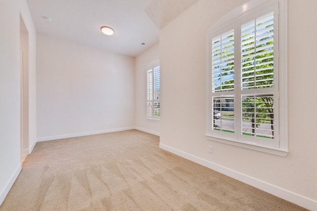 carpeted empty room featuring baseboards, visible vents, and recessed lighting