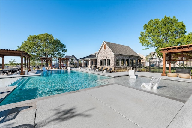pool with fence, a patio, and a pergola