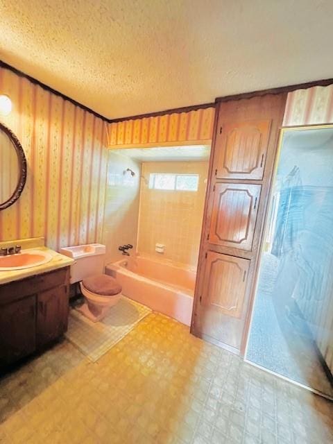 438 Atkins St, Sulphur Springs, TX 75482 - full bathroom featuring tile patterned floors, shower / washtub combination, toilet, vanity, and a textured ceiling
