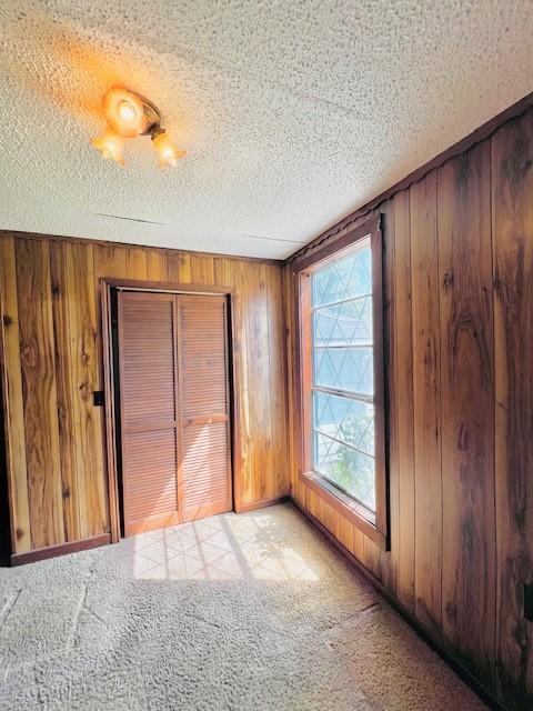 438 Atkins St, Sulphur Springs, TX 75482 - interior space featuring wood walls and a textured ceiling