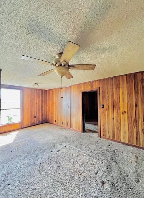 438 Atkins St, Sulphur Springs, TX 75482 - unfurnished room with wooden walls, a textured ceiling, light carpet, and ceiling fan