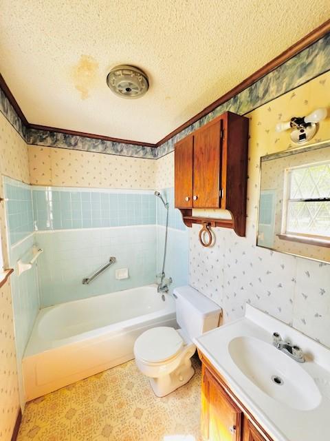 438 Atkins St, Sulphur Springs, TX 75482 - bathroom with tile patterned floors, a textured ceiling, wallpapered walls, vanity, and toilet