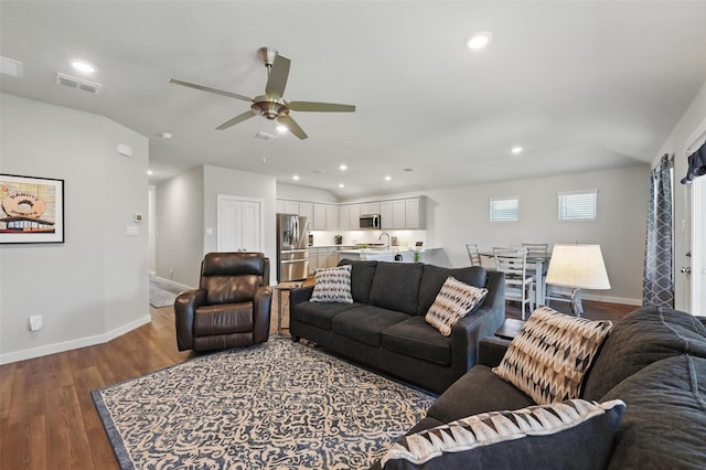 living room with baseboards, visible vents, a ceiling fan, and recessed lighting