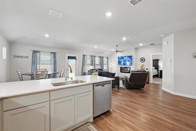 kitchen with a healthy amount of sunlight, dishwasher, visible vents, and a sink