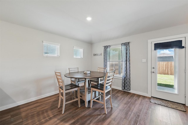 dining space with dark wood-style flooring and baseboards