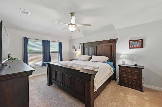 bedroom featuring visible vents, ceiling fan, baseboards, and light carpet