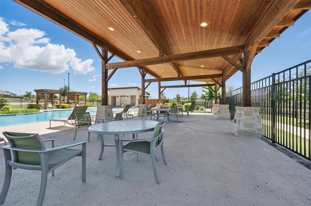 view of patio featuring fence and a community pool