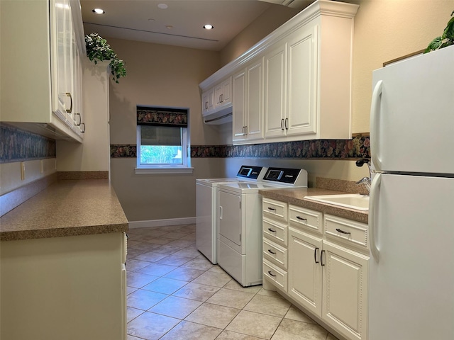 laundry room with recessed lighting, cabinet space, washing machine and dryer, a sink, and light tile patterned flooring