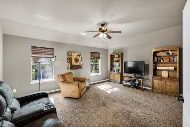 8450 Old Springtown Rd, Springtown, TX 76082 - carpeted living area featuring visible vents, baseboards, and ceiling fan