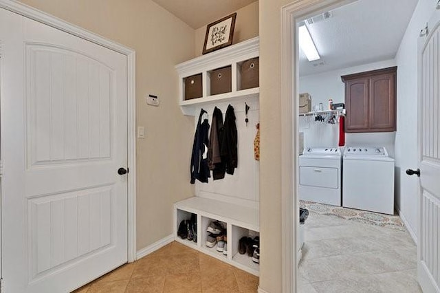 8450 Old Springtown Rd, Springtown, TX 76082 - mudroom with washer and dryer, baseboards, and light tile patterned flooring