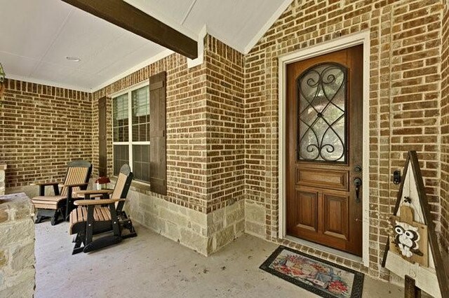 8450 Old Springtown Rd, Springtown, TX 76082 - property entrance with brick siding and covered porch
