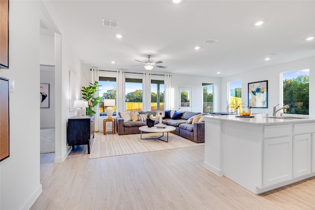 living room featuring visible vents, ceiling fan, light wood-type flooring, and recessed lighting