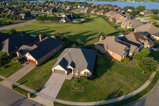drone / aerial view with a residential view and a water view