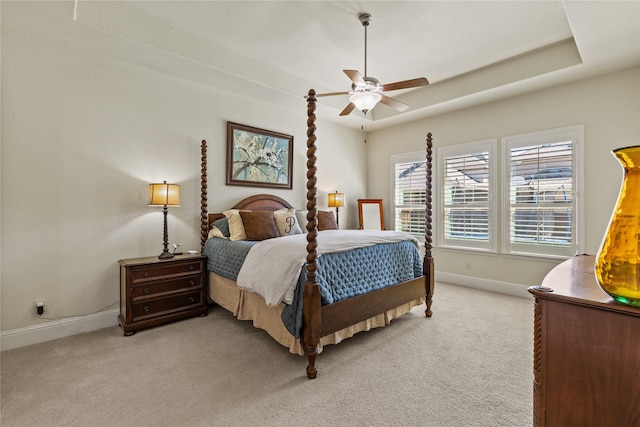 bedroom with light carpet, a ceiling fan, and baseboards