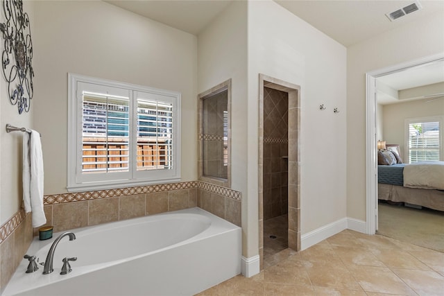 full bathroom featuring ensuite bathroom, a bath, tile patterned flooring, visible vents, and tiled shower