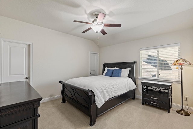 bedroom featuring light colored carpet, baseboards, and a ceiling fan