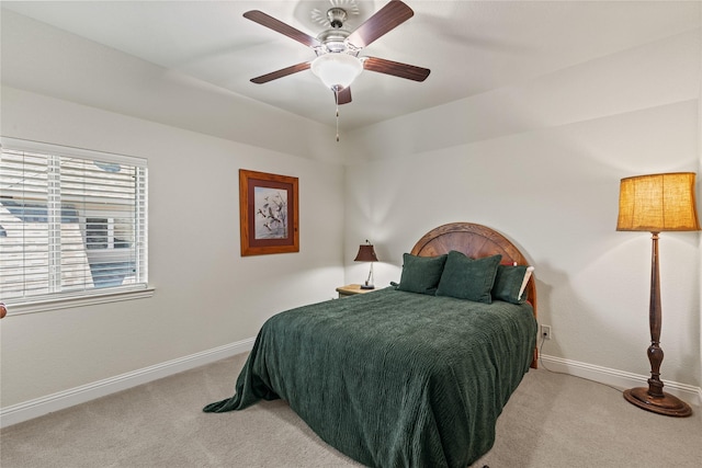 carpeted bedroom with baseboards and ceiling fan