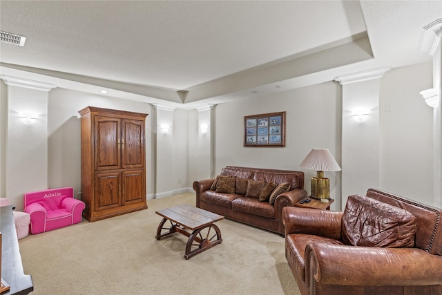 living area featuring light colored carpet, visible vents, and ornate columns
