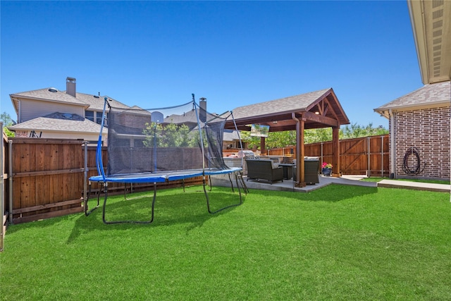 view of yard featuring a patio area, a fenced backyard, outdoor lounge area, and a trampoline