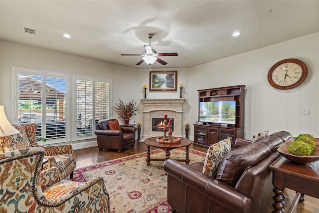living area with recessed lighting, wood finished floors, visible vents, a fireplace, and ceiling fan